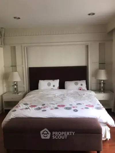 Elegant bedroom with stylish decor and cozy bedding in a modern real estate property.