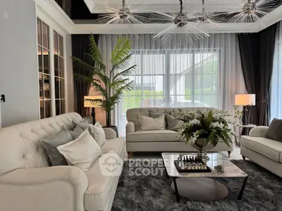 Luxurious living room with elegant sofas, stylish lighting, and large windows for natural light.