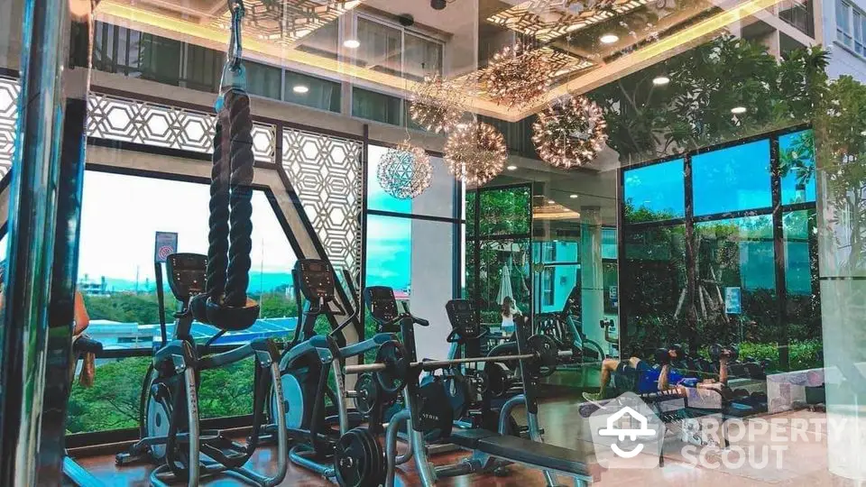 Luxurious gym with modern equipment and stunning outdoor views in high-end real estate property.