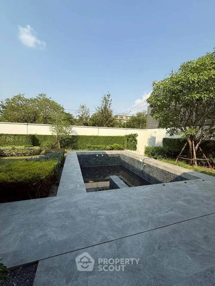 Luxurious private garden with a modern pool and lush greenery, perfect for relaxation and outdoor enjoyment.