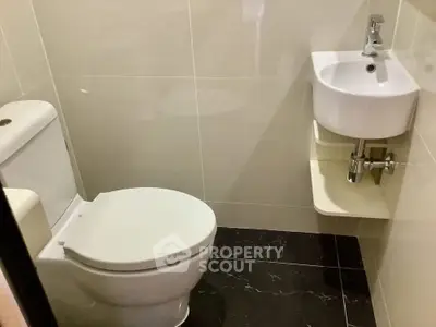 Compact modern bathroom with sleek fixtures and tiled flooring