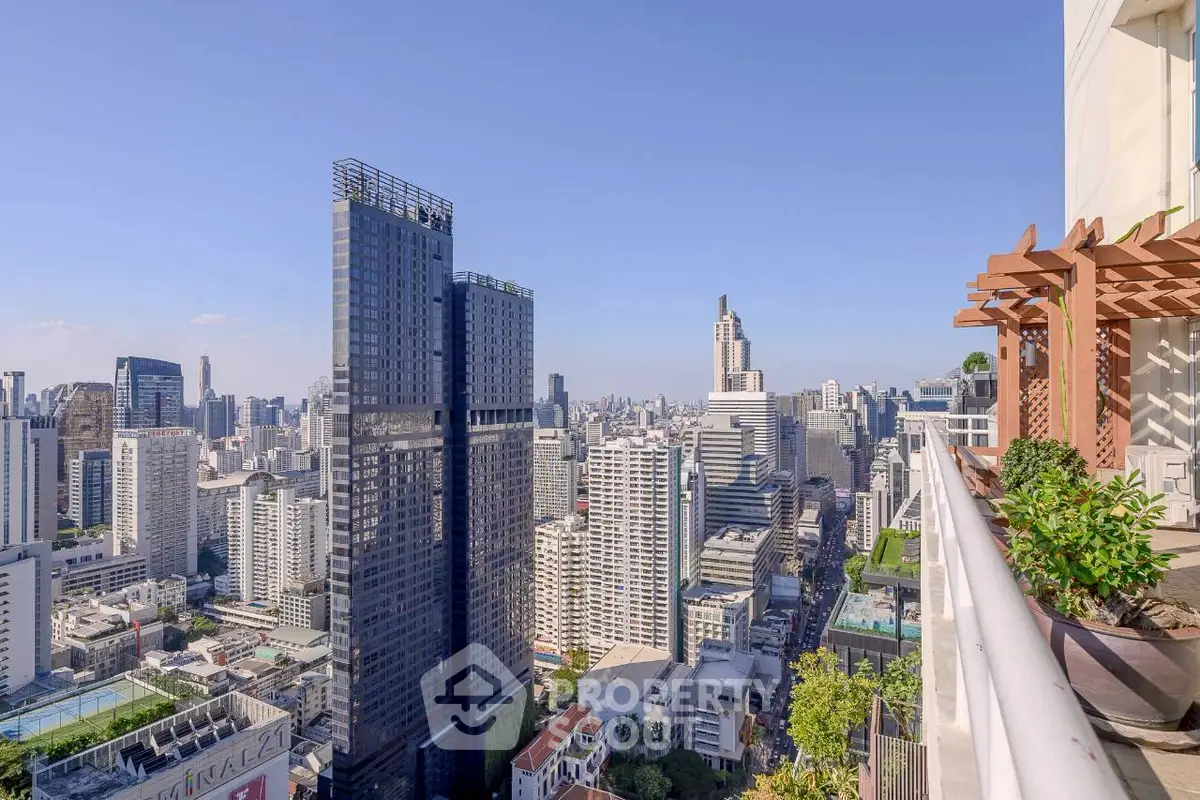 Stunning cityscape view from a high-rise balcony with modern urban skyline.