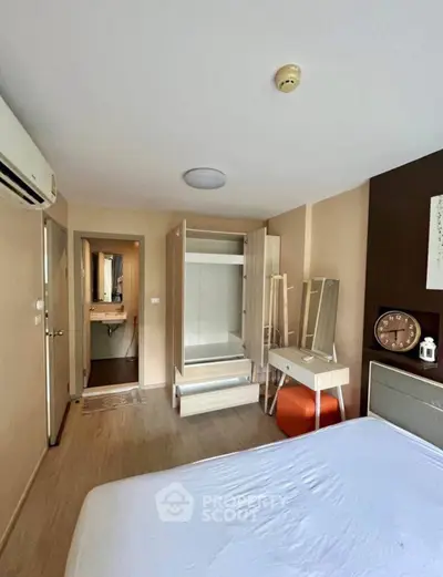 Cozy bedroom with modern furnishings and ample storage in a stylish apartment.