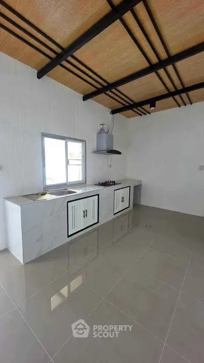 Modern kitchen with sleek countertops and stylish ceiling design