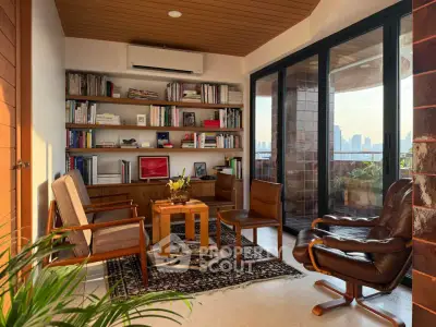 Chic living room with city view, stylish furniture, and floor-to-ceiling windows in modern apartment.