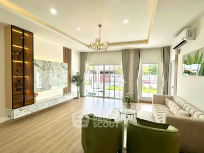 Spacious modern living room with elegant decor and large windows offering garden views.