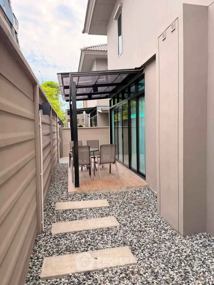 Modern outdoor patio with stylish furniture and sleek design in a contemporary home setting.