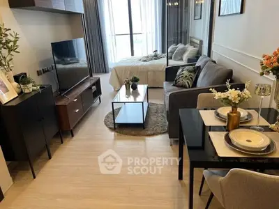 Modern open-plan living room with cozy seating and stylish decor, featuring a dining area and large window view.