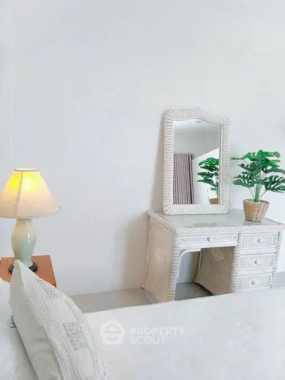 Elegant bedroom with wicker furniture and soft lighting, perfect for a serene retreat.
