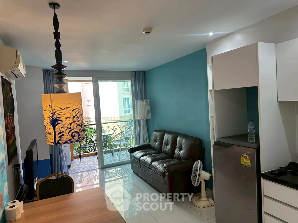 Charming living room with balcony access and modern decor in a cozy apartment.