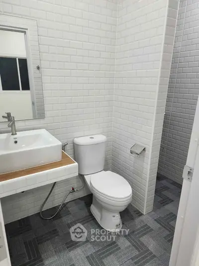 Modern bathroom with white subway tiles and sleek fixtures