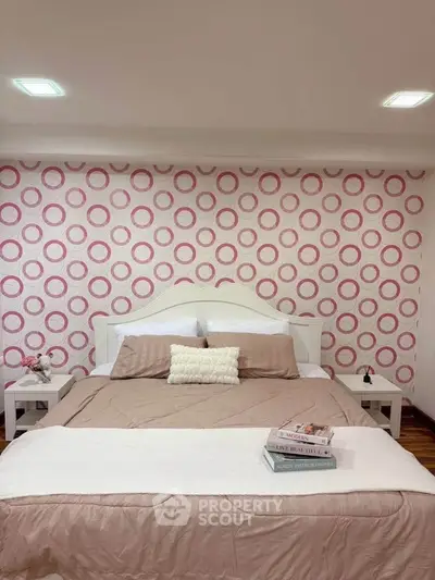 Cozy bedroom with stylish pink circle wallpaper and elegant decor
