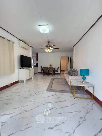 Spacious living room with modern decor and marble flooring