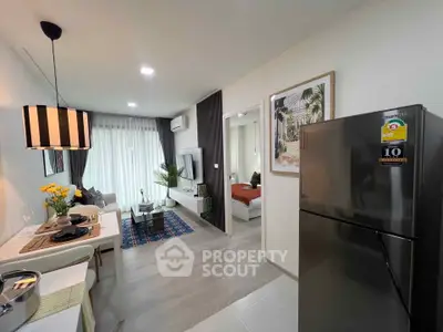 Modern open-plan living room and kitchen with stylish decor and natural light