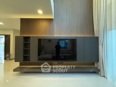 Modern living room with sleek TV unit and elegant curtains