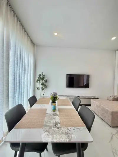 Modern living room with elegant dining area and sleek decor