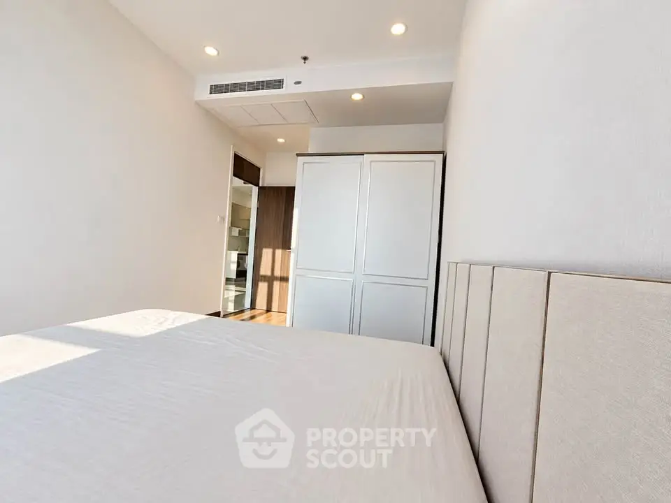 Modern bedroom with minimalist design and ample natural light