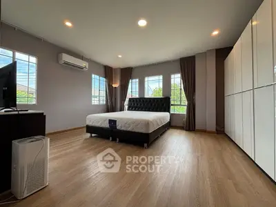 Spacious modern bedroom with large windows and stylish decor