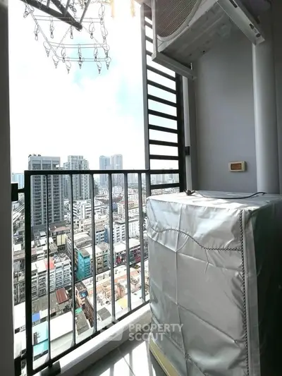 High-rise balcony with cityscape view and air conditioning unit, perfect for urban living.