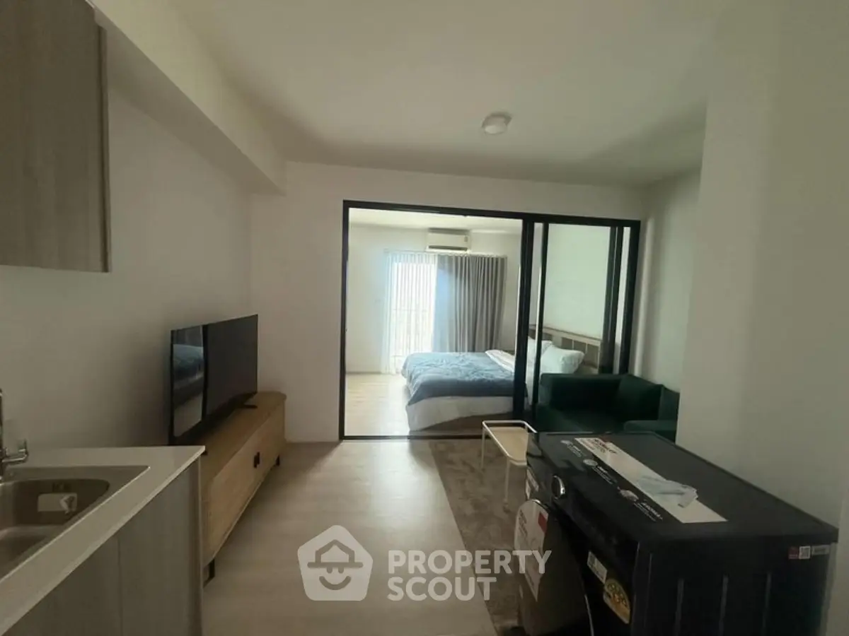 Modern studio apartment with open layout and cozy bedroom area