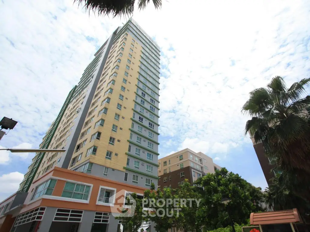 Stunning high-rise building with lush greenery and clear sky view, perfect for urban living.