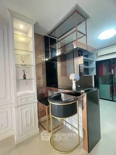 Modern kitchen with sleek bar counter and elegant shelving in contemporary apartment.