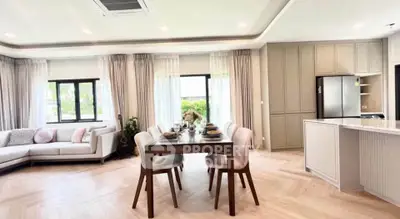 Spacious open-plan living and dining area with modern kitchen and elegant decor.