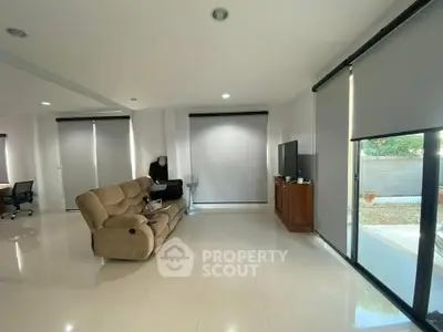Spacious living room with modern decor and large windows for natural light.
