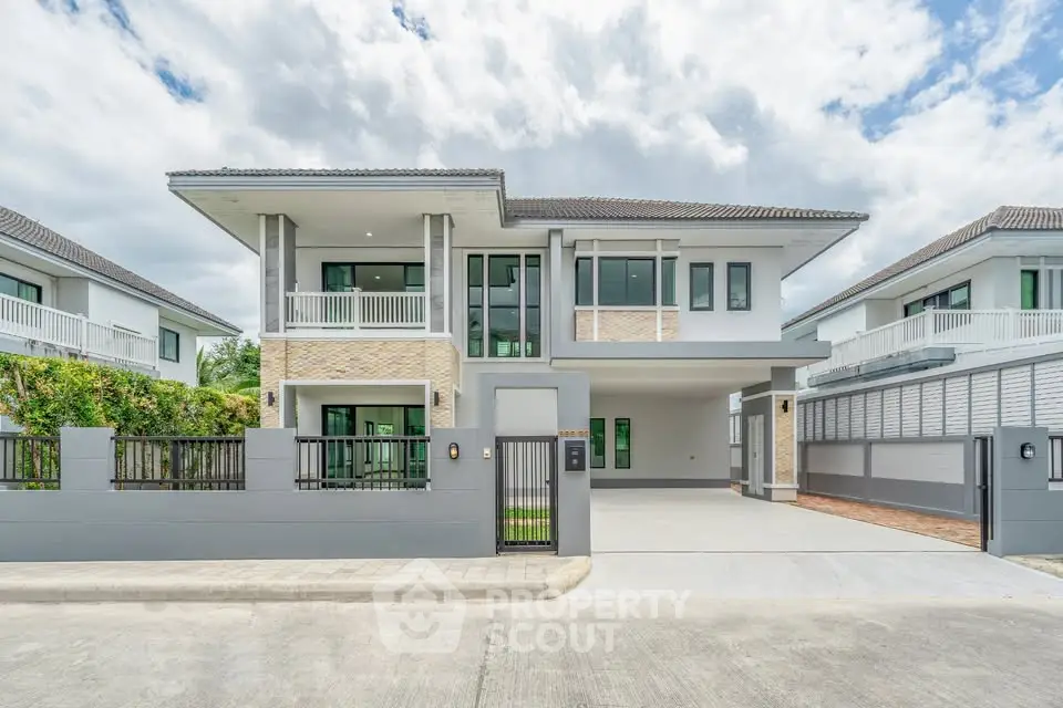 Modern two-story house with spacious driveway and elegant facade in a serene neighborhood.