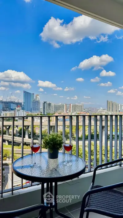 Stunning balcony view with cityscape and cozy seating area.