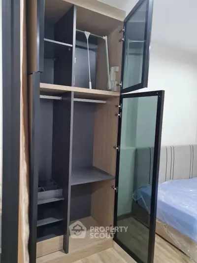 Modern bedroom with sleek wardrobe and cozy bed setup