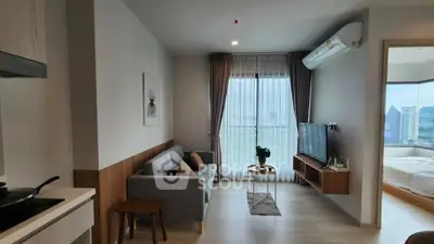 Modern living room with city view, cozy sofa, and stylish decor