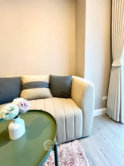 Stylish living room with modern sofa and elegant decor in a cozy apartment setting.