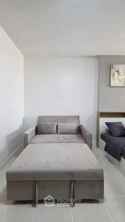 Modern living room with stylish gray sofa bed and minimalist decor