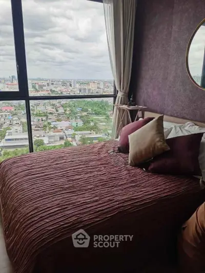 Luxurious bedroom with stunning city view from floor-to-ceiling windows, featuring elegant decor and plush bedding.
