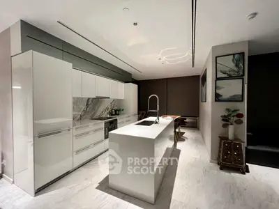 Modern kitchen with sleek white cabinetry and marble accents
