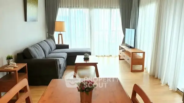 Spacious living room with modern furniture and large windows for natural light.