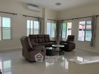 Spacious living room with modern furniture and large windows for natural light.