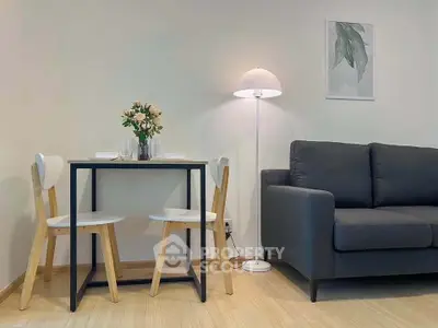 Modern living room with cozy sofa, stylish dining set, and elegant floor lamp.