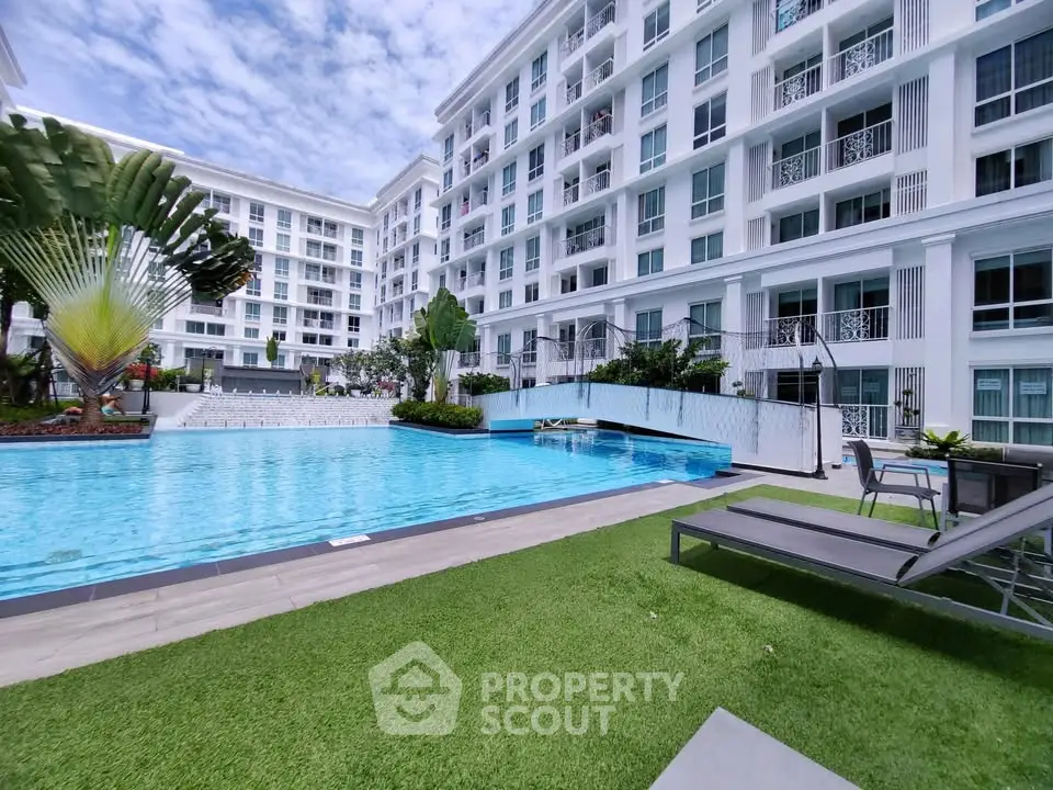 Luxurious apartment complex with a stunning pool and lush greenery, perfect for modern living.