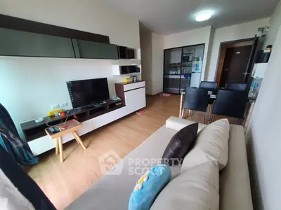 Modern living room with sleek furniture and entertainment center in a cozy apartment.
