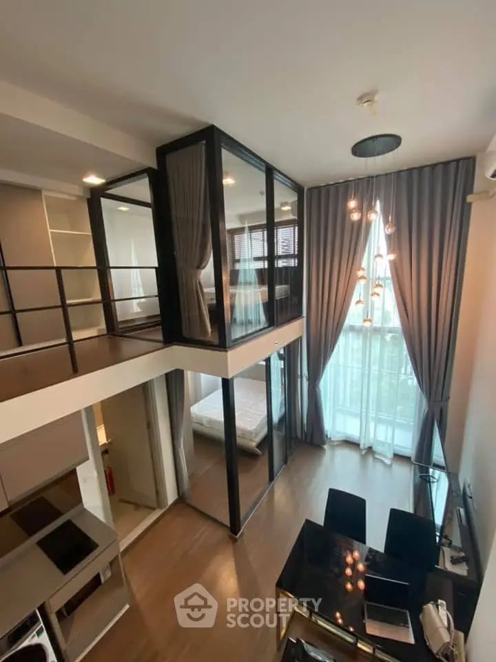 Modern loft apartment with high ceilings, large windows, and stylish interior design.