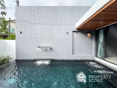 Luxurious modern pool with sleek water feature and elegant design