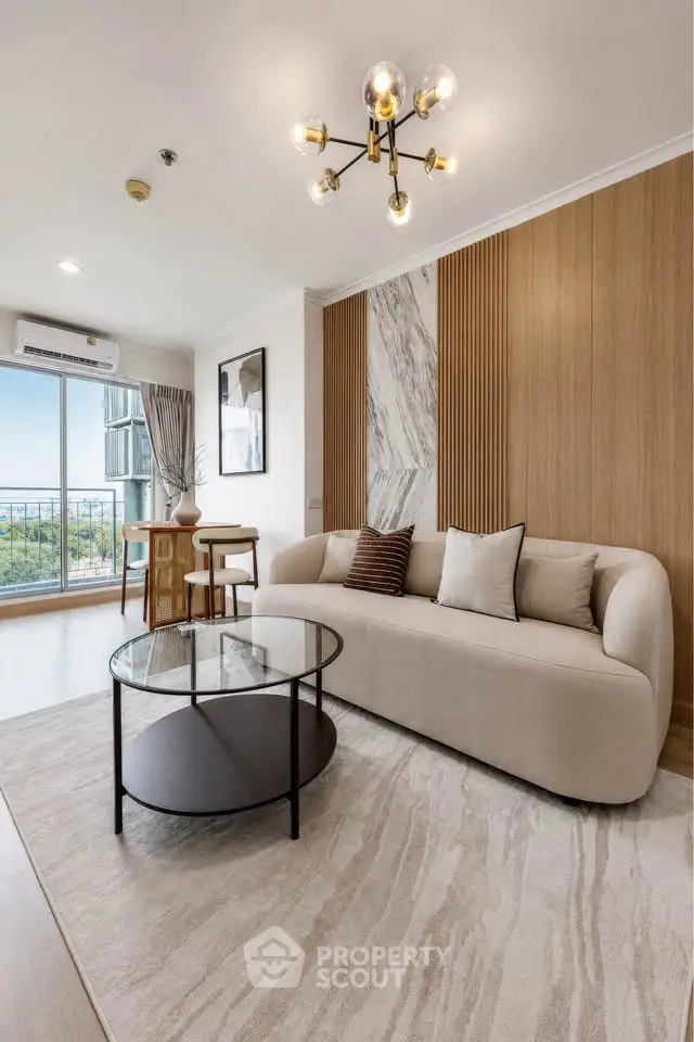 Modern living room with elegant decor and large window offering a scenic view, featuring a stylish sofa and chic lighting.