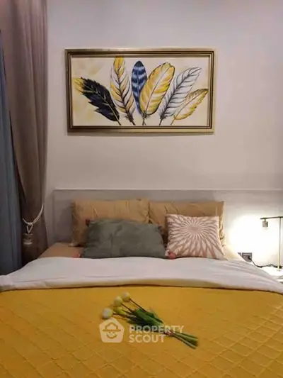Cozy bedroom with stylish decor and vibrant artwork above the bed.