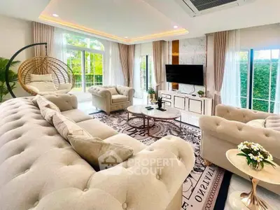 Luxurious living room with elegant decor and large windows offering garden views.