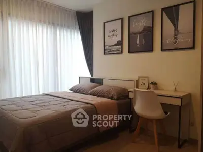 Cozy bedroom with modern decor and natural light, perfect for relaxation and comfort.