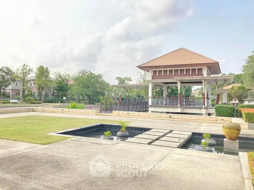 Stunning garden view with elegant pavilion and lush greenery in a serene residential area.