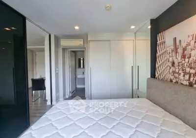 Modern bedroom with mirrored closet doors and cityscape artwork, featuring sleek design and ample natural light.