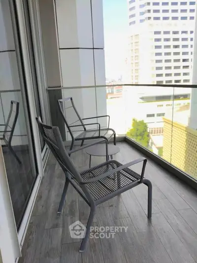 Modern balcony with stylish chairs and city view, perfect for relaxation and enjoying urban living.